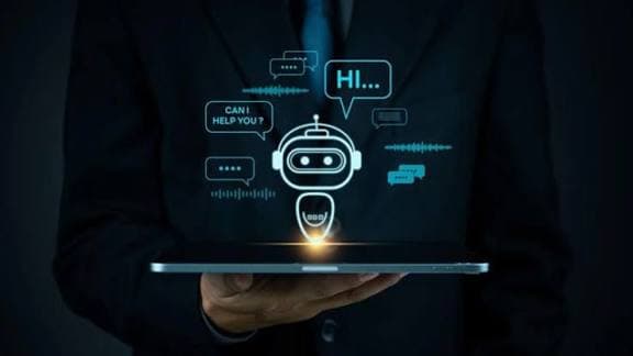 Businessman holding a tablet with a glowing chatbot icon and floating digital speech bubbles.